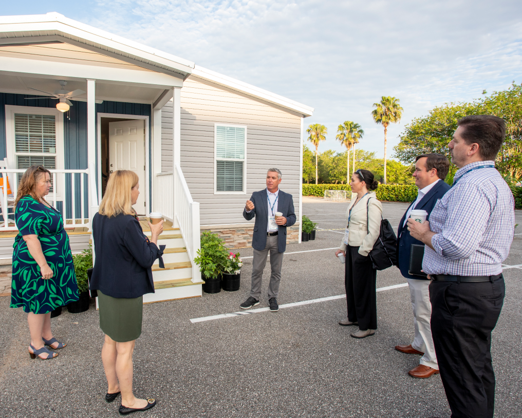 Group speaking outside house